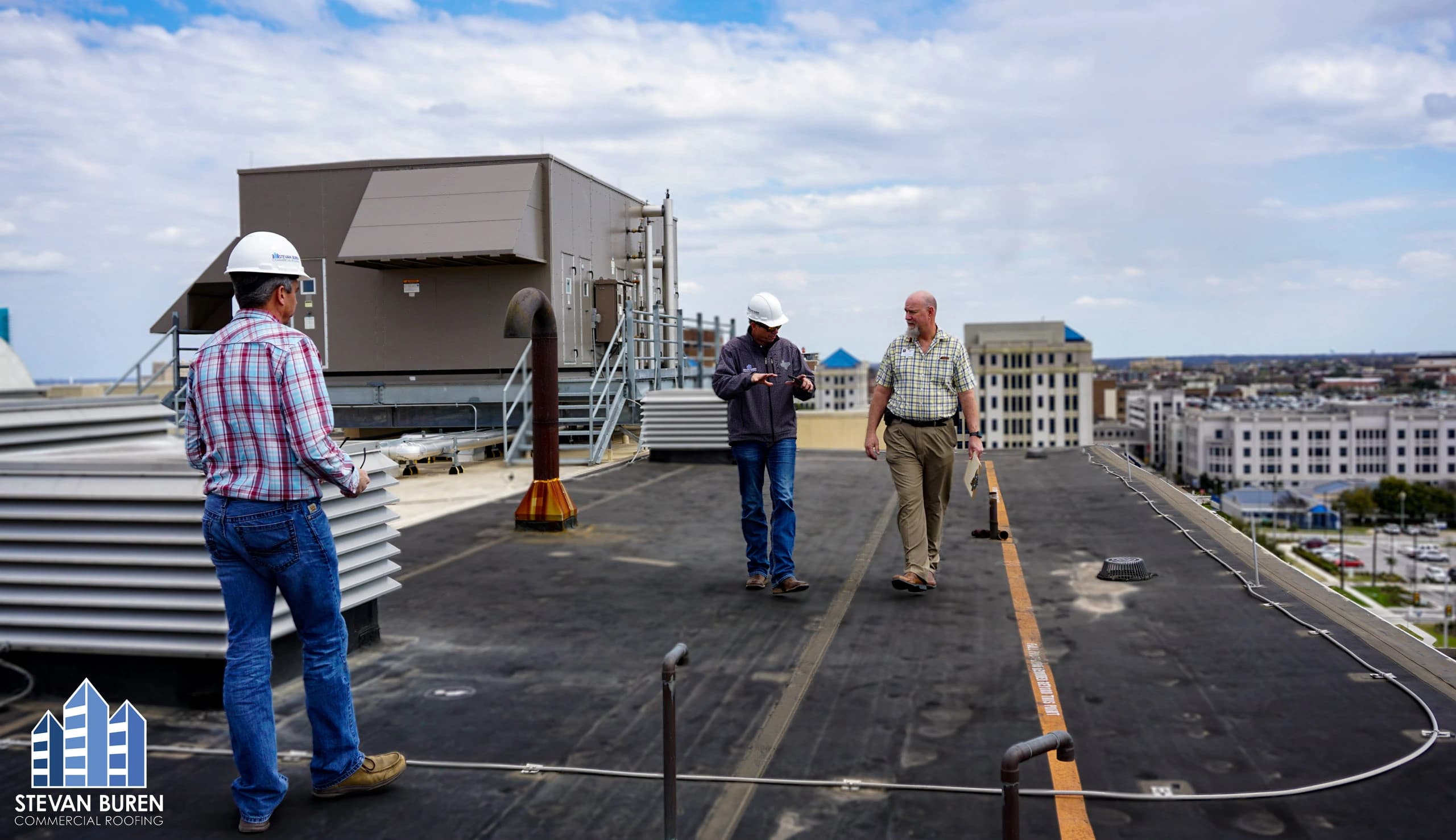 Commercial roof inspection on a flat roof with rooftop equipment