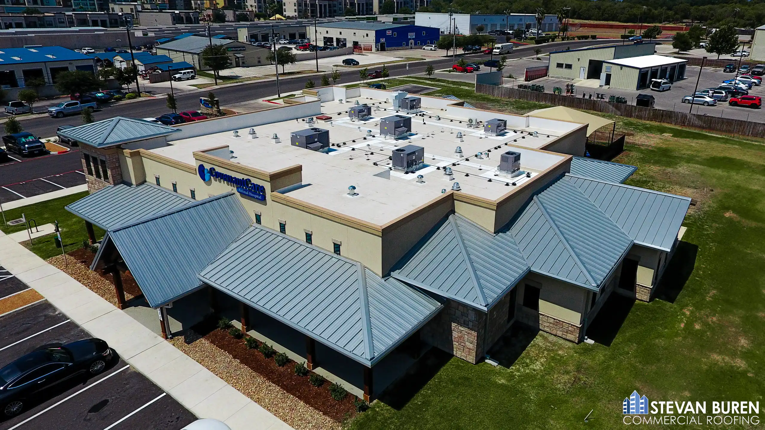Retail property with flat commercial roof and metal roof sections