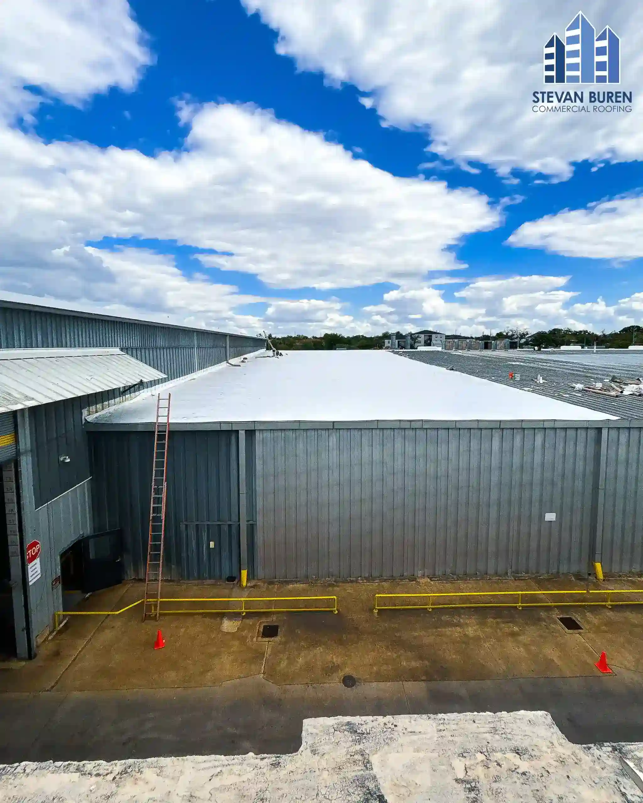 Factory metal roof with a white roof coating system